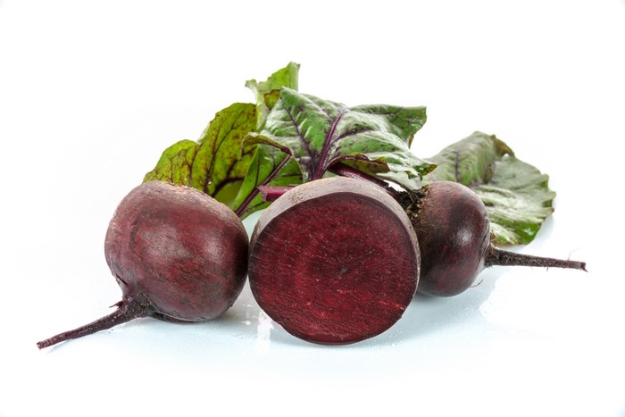 Beets with leaves on white background