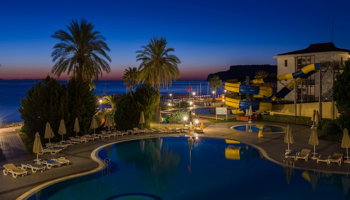 Resort with pools and water slides at dusk in Turkey