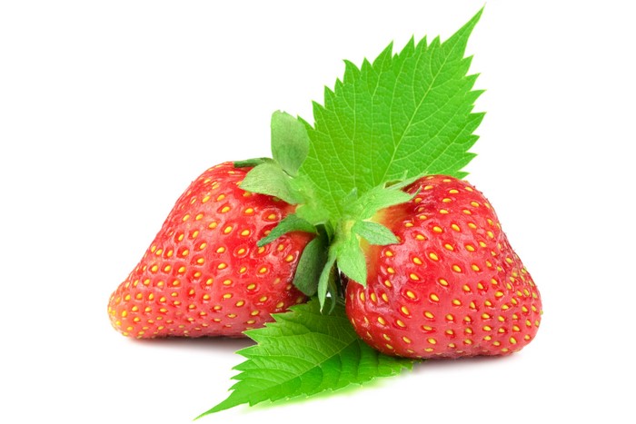 Two Strawberries with Green Leaves on White Background