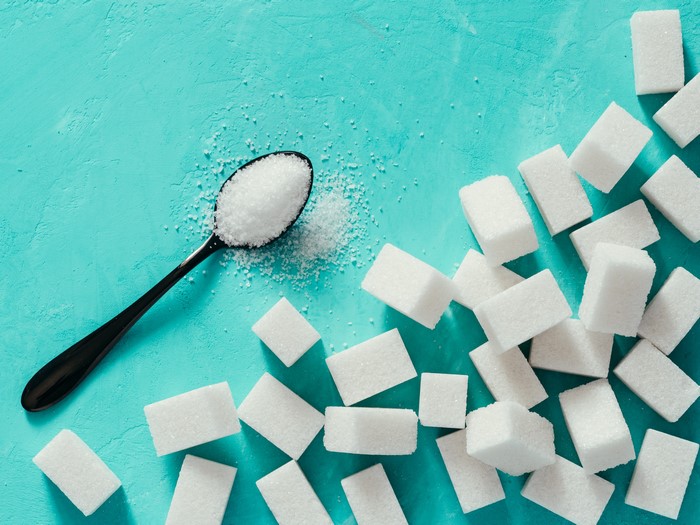 Sugar cubes and spoon with sugar