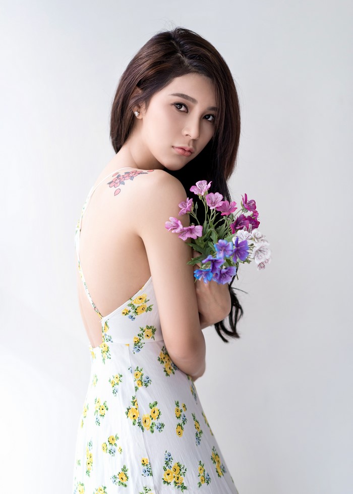 Asian woman with flowers and tattoo