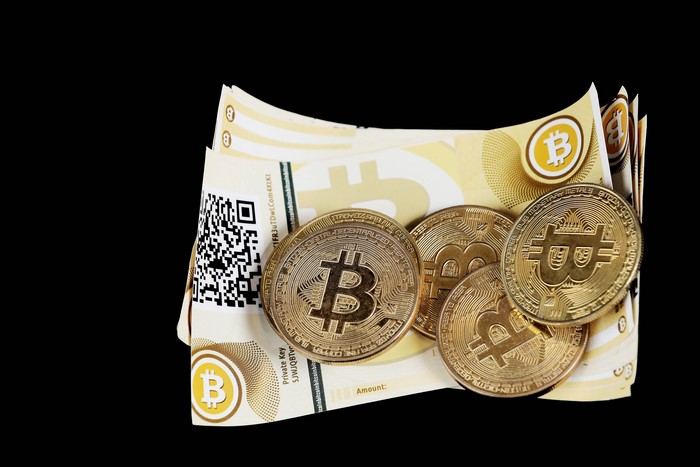 Bitcoin coins and banknotes with QR code