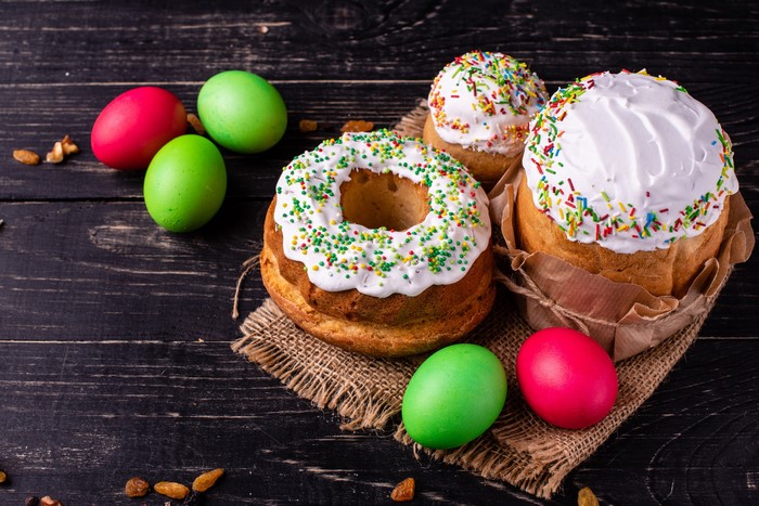 Easter Kulich cakes with colorful sprinkles and dyed eggs
