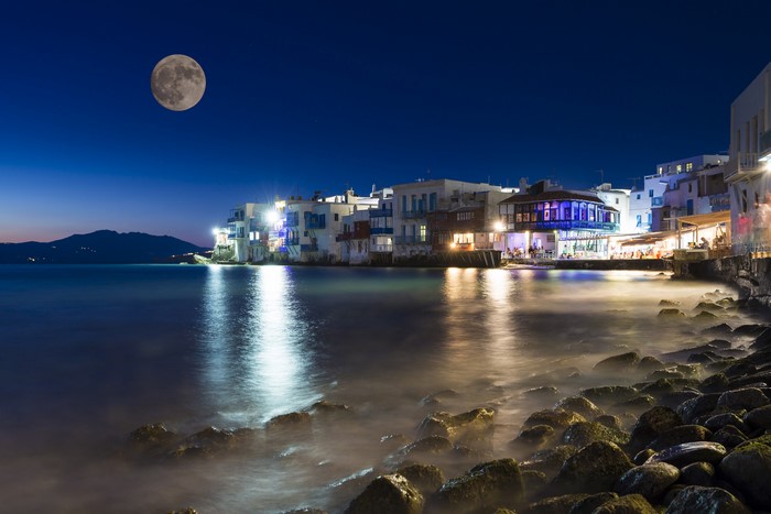 Mykonos island Greece coast at night with moon