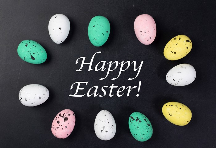Happy Easter text with multicolor eggs on black background