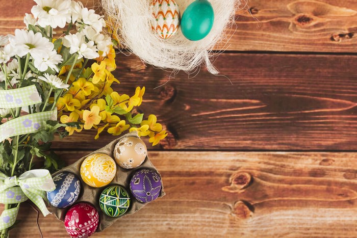 Easter eggs and flowers on wooden planks