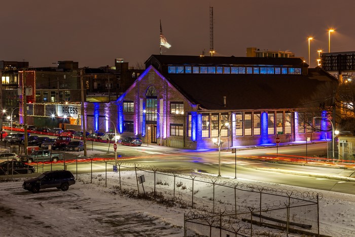 Brick building with blue lights at night in winter