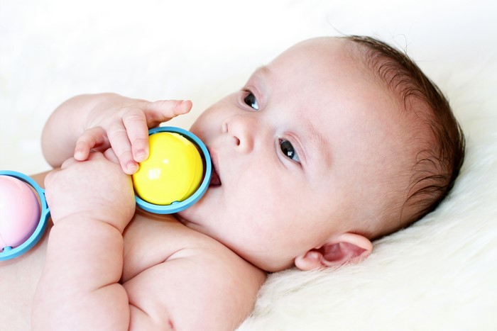 Baby playing with a rattle toy