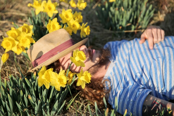 Man in Hat Lying in Daffodils