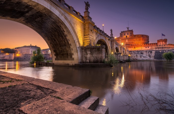 Castel Sant'Angelo bridge over Tiber River at dusk, Rome