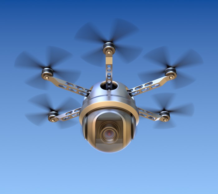 Hexacopter drone with camera flying in blue sky