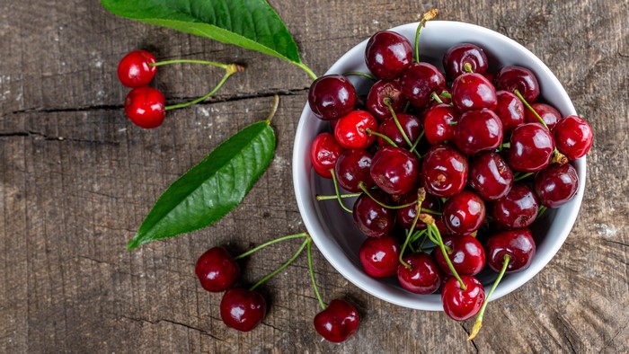 Cherries in a bowl on a wooden table