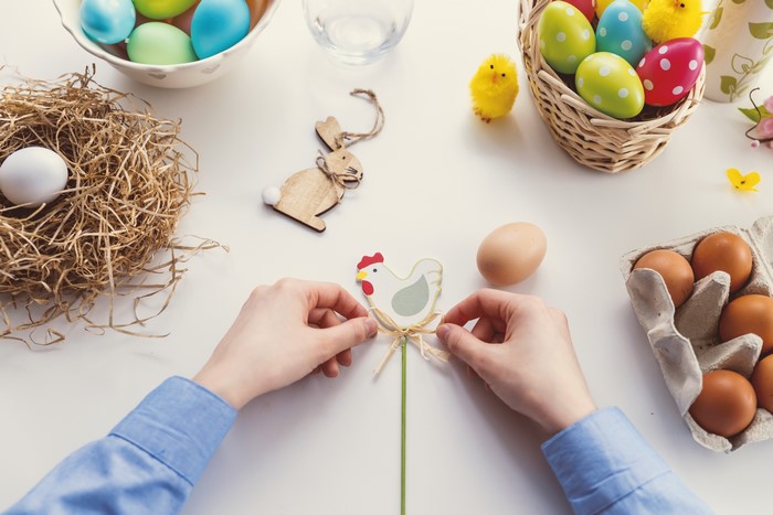 Easter eggs and decorations with hands