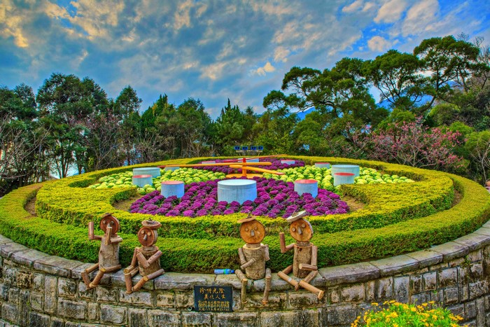 Flower clock sculpture garden with wooden figures in Taiwan