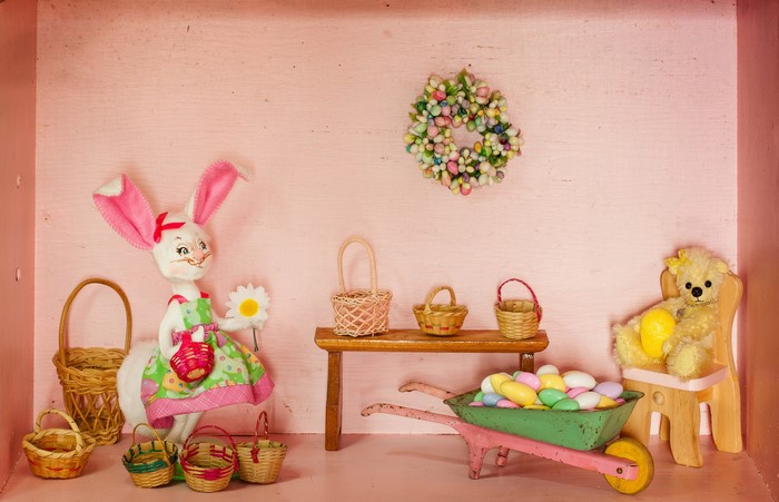 Easter scene with bunny, teddy bear, baskets, and eggs