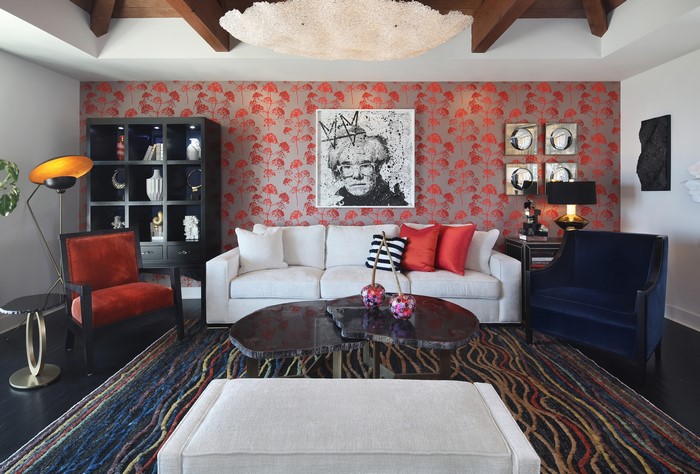 Living room with Andy Warhol portrait and red floral wallpaper
