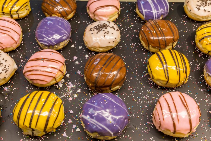 Assortment of colorful iced donuts with sprinkles