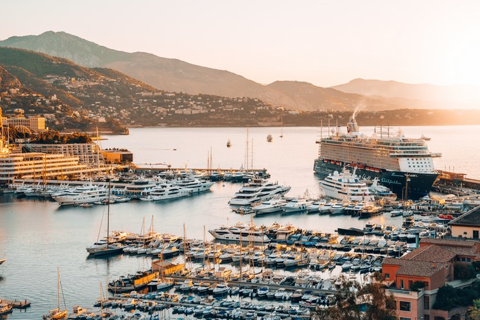 Cruise liner and yachts in Monte Carlo harbor at sunset