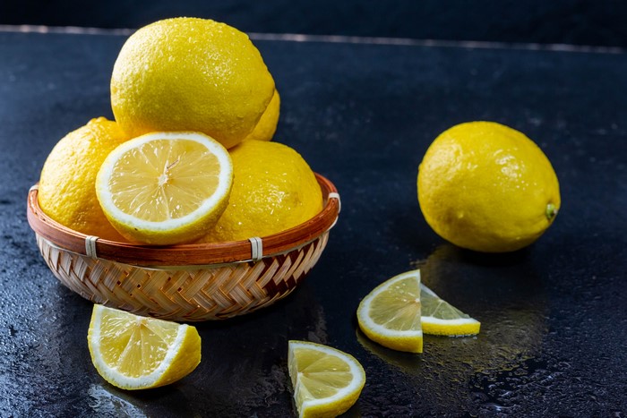 Lemons in a wicker basket with slices