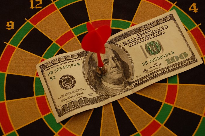One Hundred Dollar Bill on Dartboard with Dart