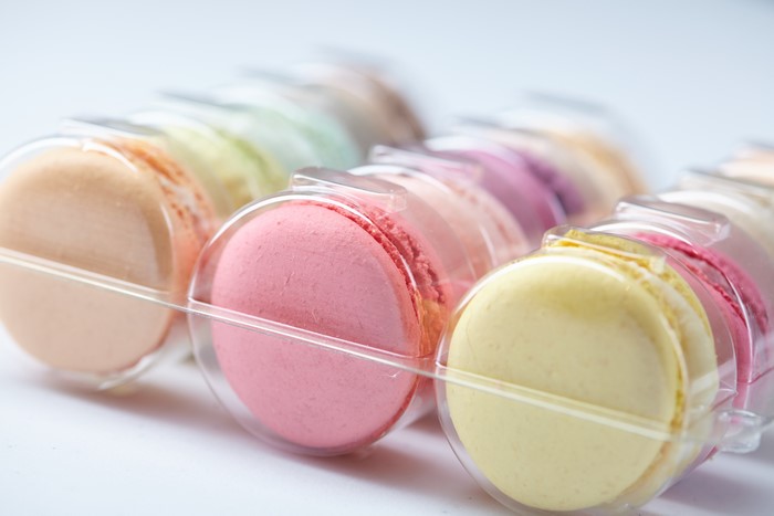 Assortment of colorful macarons in plastic packaging