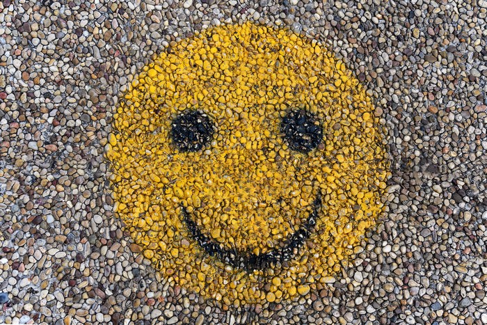 Graffiti smiley face on pebbles