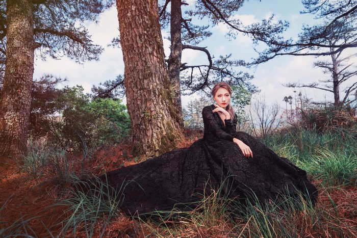 4K Asian Woman Sitting in Dress Among Trees