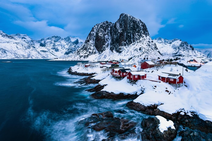 Red houses on snowy coast of Lofoten, Norway