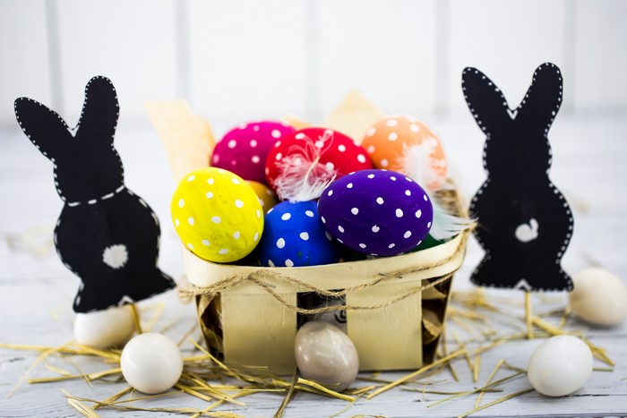 Easter eggs in a basket with black rabbits