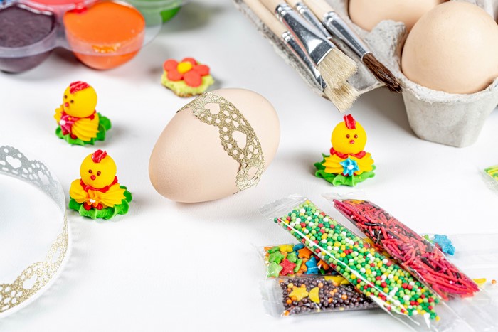 Easter egg decorating supplies with chicks and sprinkles