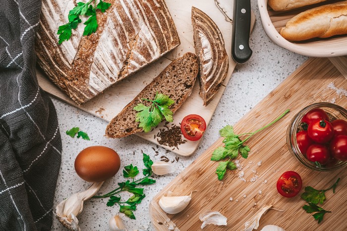 Bread, Tomatoes, Garlic, Egg, and Cutting Board