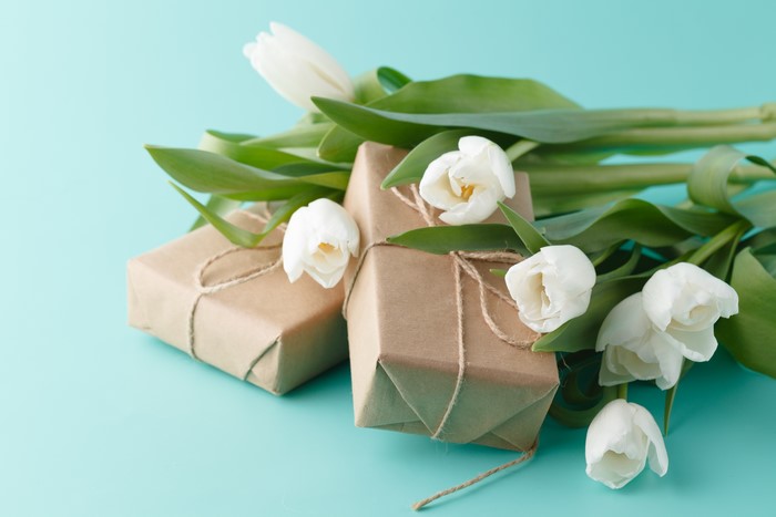 White Tulips and Gifts on a Teal Background