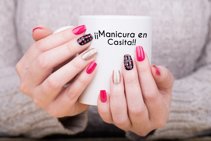 Hands with Manicure Holding Mug with Text