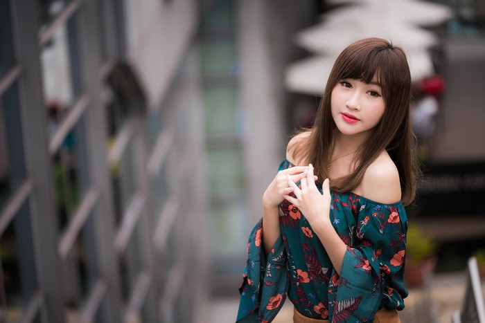 Cute Asian girl with brown hair in a floral top