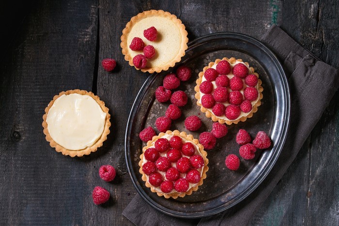 Raspberry tarts on a wooden table