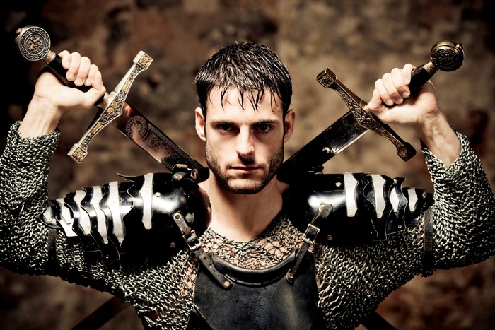 Man in Knight Armor Holding Two Swords