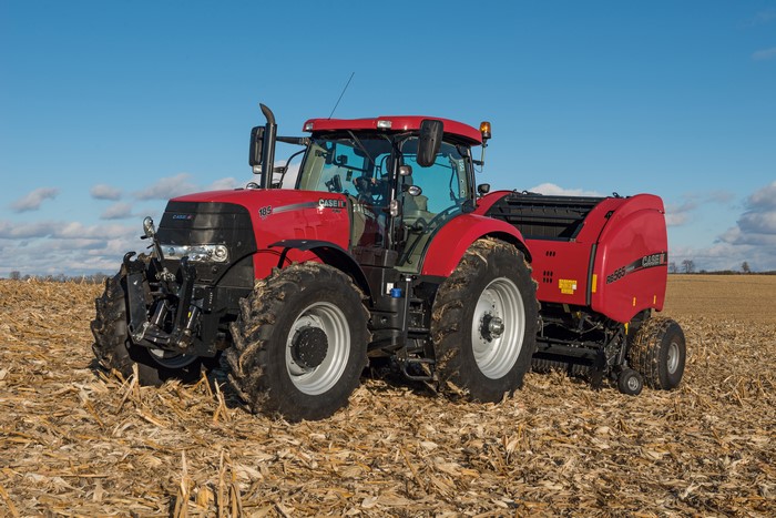 Case IH Puma 185 CVT tractor with baler in a field