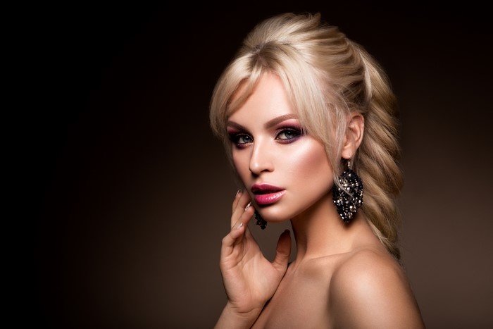 Blonde woman with makeup and earrings