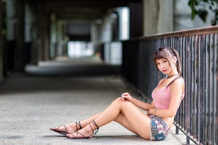 4K Asian Woman Sitting Beside Fence