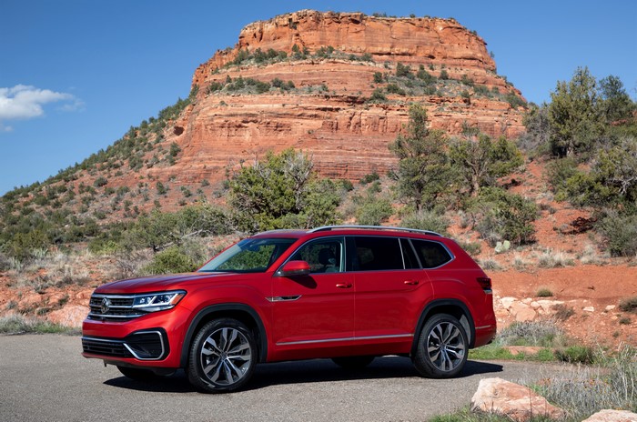 Red Volkswagen Atlas parked in front of a red rock formation