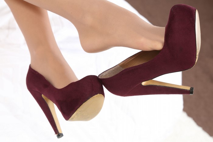 Legs in Pantyhose and Burgundy Stilettos