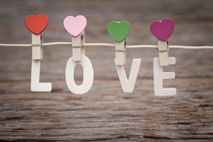 Wooden letters spelling LOVE with heart clothespins