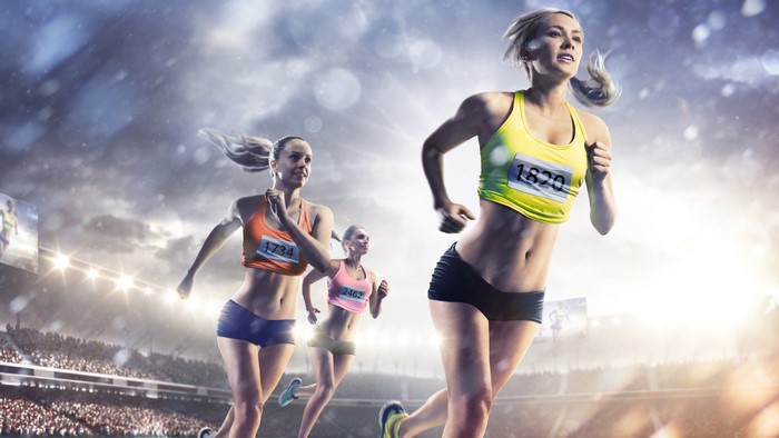 Female runners in a stadium race