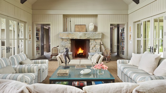 Living room with fireplace, sofas, and armchairs