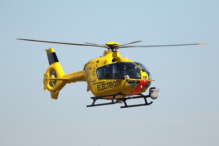 Yellow EC135 Helicopter G-WPDB in Flight
