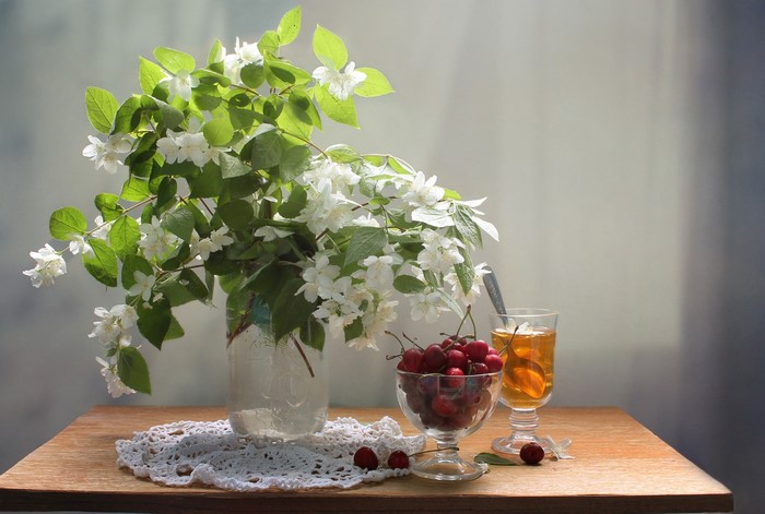 Still life with jasmine, cherries, and tea