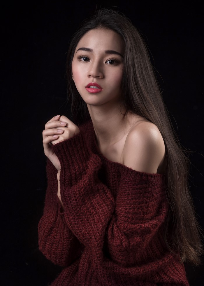 Woman in a maroon sweater with long hair