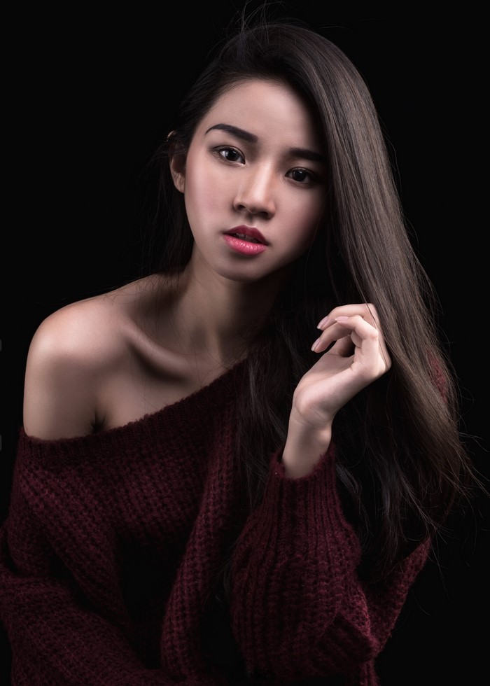 Asian woman with long hair wearing a sweater