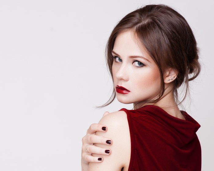 Woman with dark hair and red lipstick