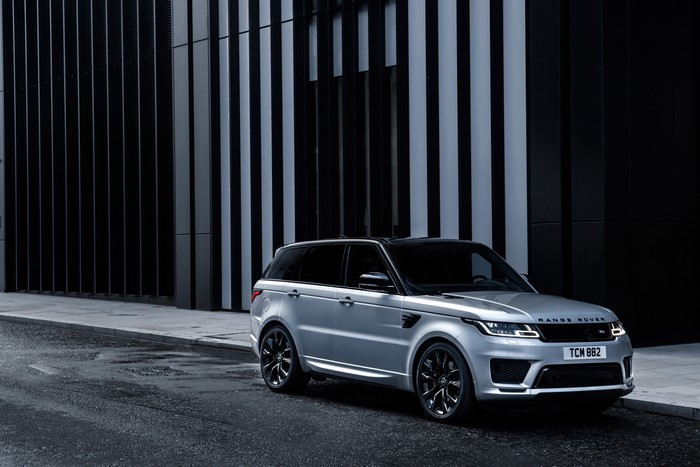 Silver Range Rover Sport HST parked on wet street